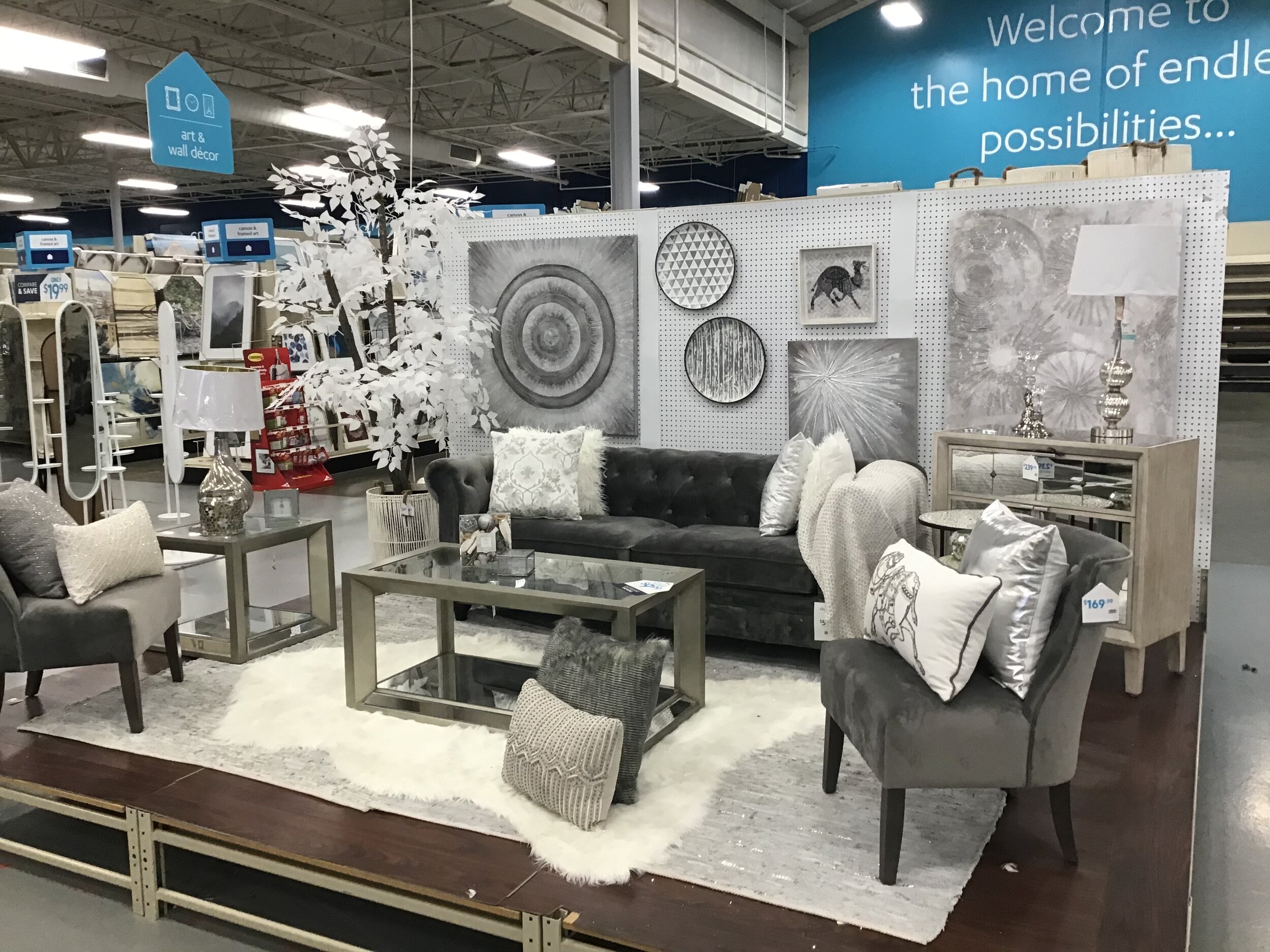 A furniture vignette at the Greensboro store. The showcase includes a chair and coffee table for $169 each and a $599 Chesterfield sofa.